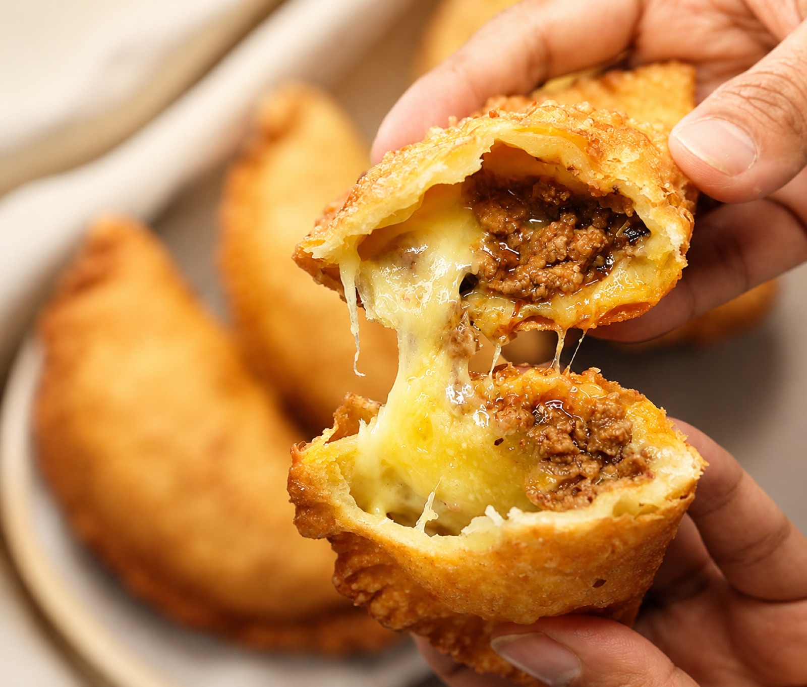 Empanada cheese pull close-up